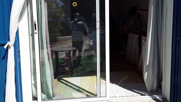 A room with a sliding glass door leading to an outdoor area.