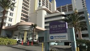 The Ocean Walk Resort building with a sign indicating luxury hotel suites.