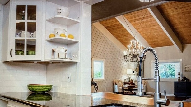 A kitchen with a large stainless steel sink, white cabinetry, and a wooden ceiling. - Beautiful Farmhouse with serene environment. 4+ acres beautiful landscape. 
 (Wallis)
