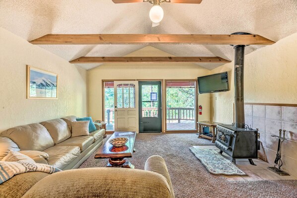 A cozy living room with a sofa, a coffee table, and a fireplace.