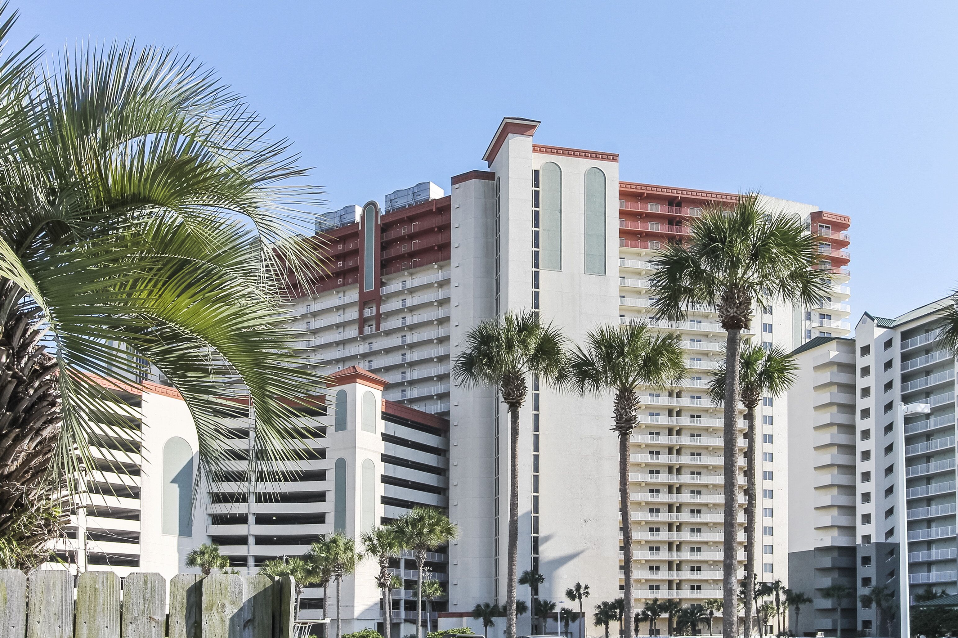 A multi-story hotel with a modern design, featuring balconies and a prominent vertical structure.