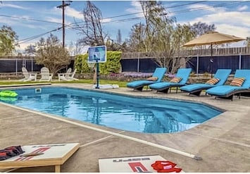 The outdoor oasis has a heated pool, fire pit, yard games and plenty of seating!