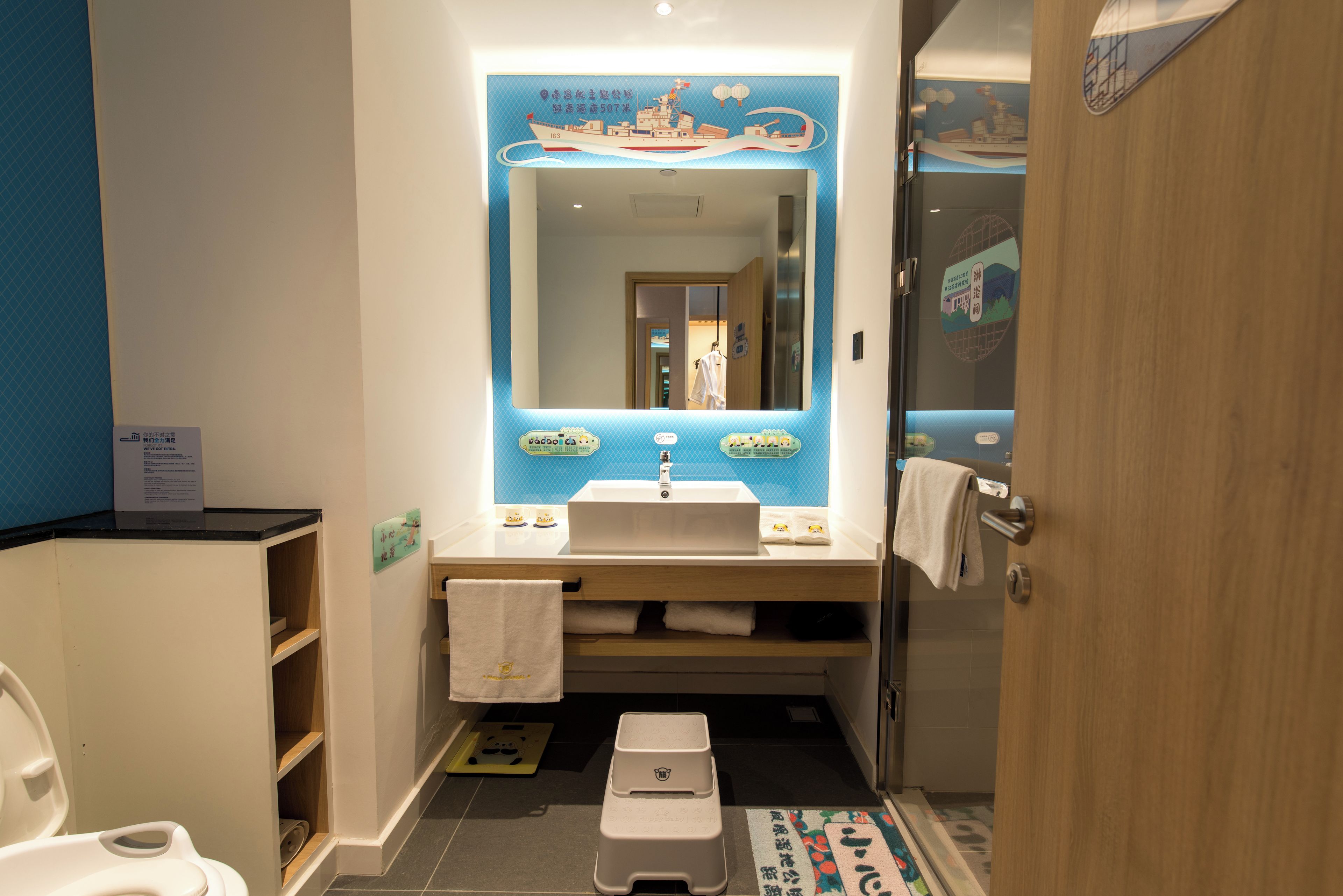 A bathroom with a sink, mirror, and toilet.