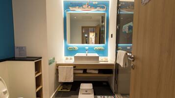 A bathroom with a sink, mirror, and toilet.