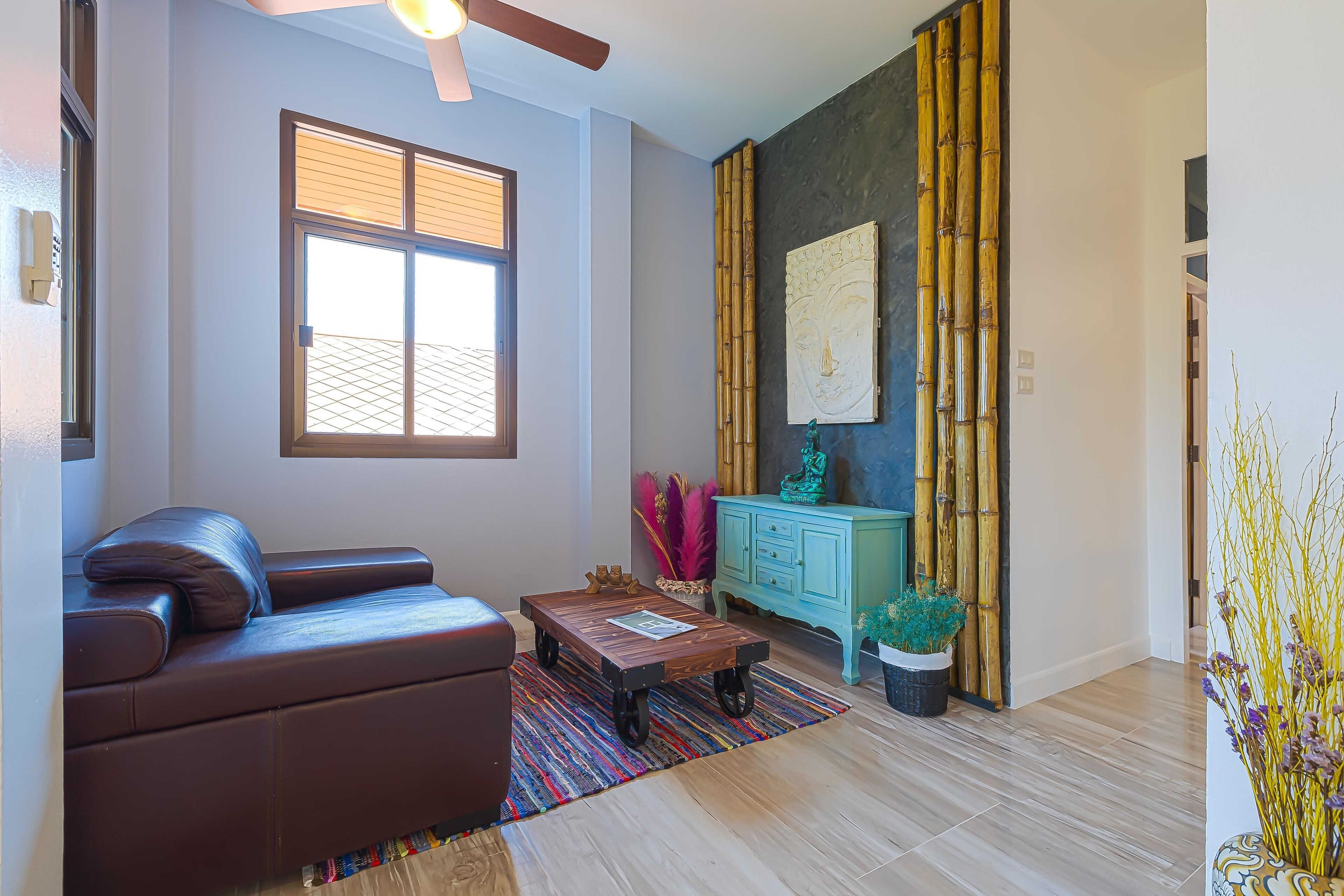 A modern living room with a sofa, coffee table, and decorative items.