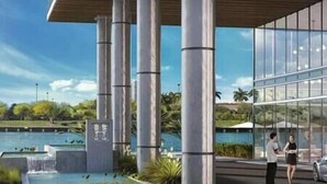 A modern building with large glass windows, a water feature, and a view of a lake. - 2402 Hyde House Ocean View 2 Be 2 Ba, Special Amenities (Hollywood)