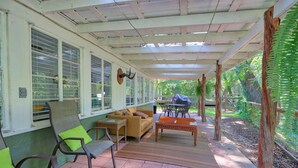 A covered patio area with seating, a table, and a decorative antler.