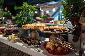 A buffet with various desserts and pastries.