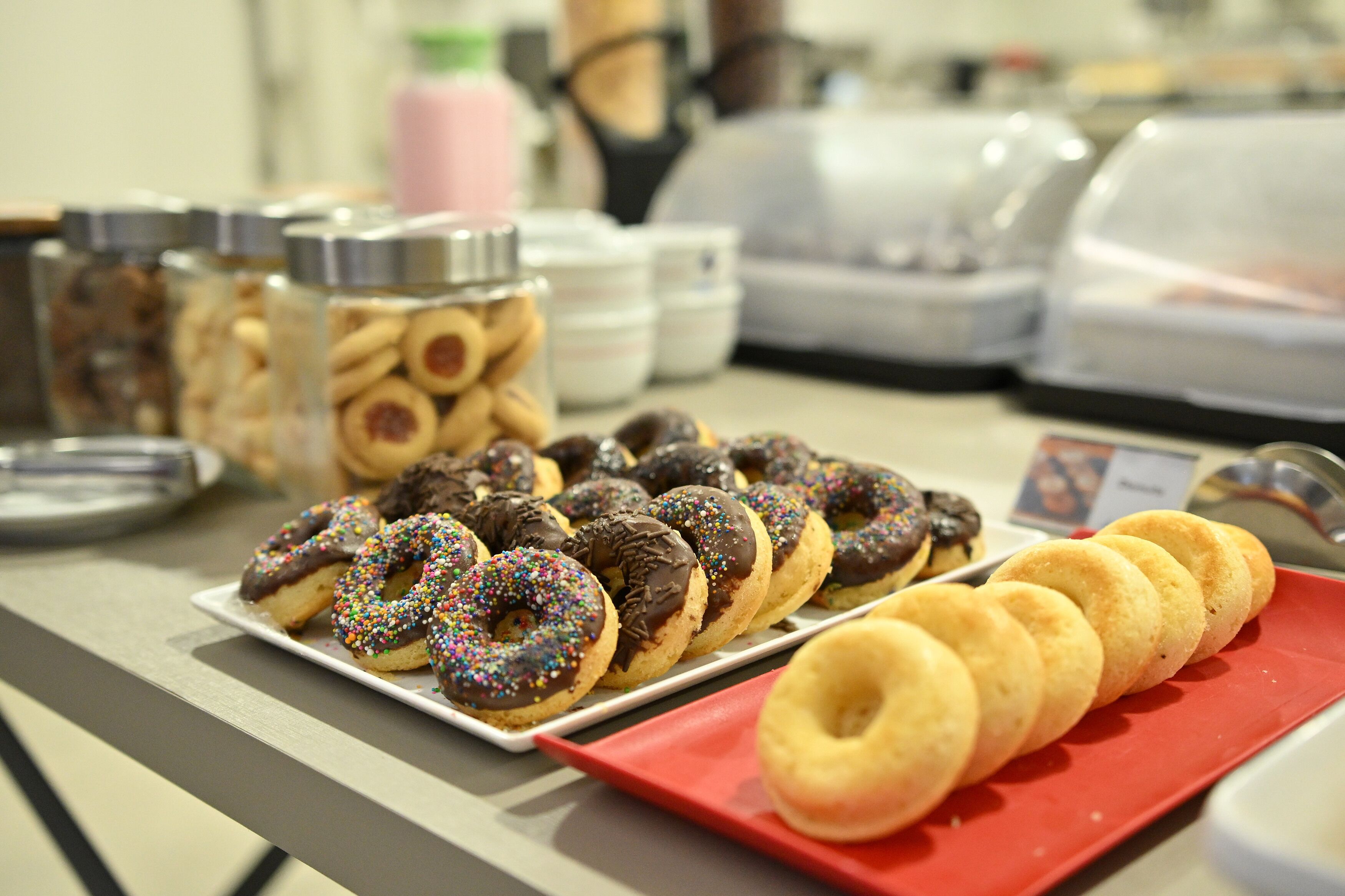 A buffet with various pastries and cookies displayed on trays.