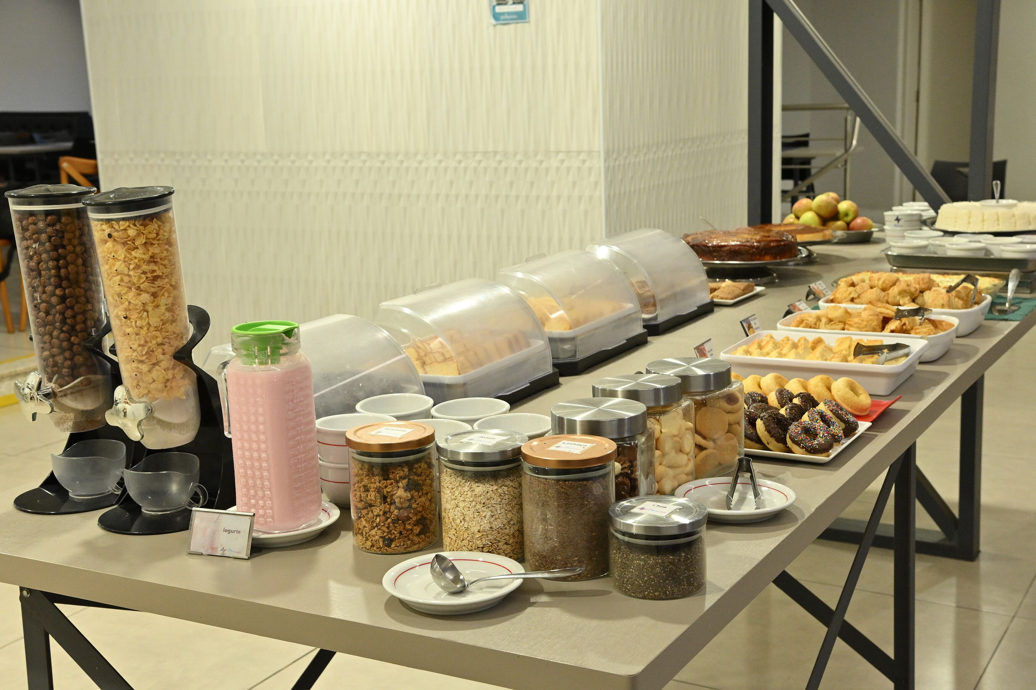 A buffet table with various food items and containers.