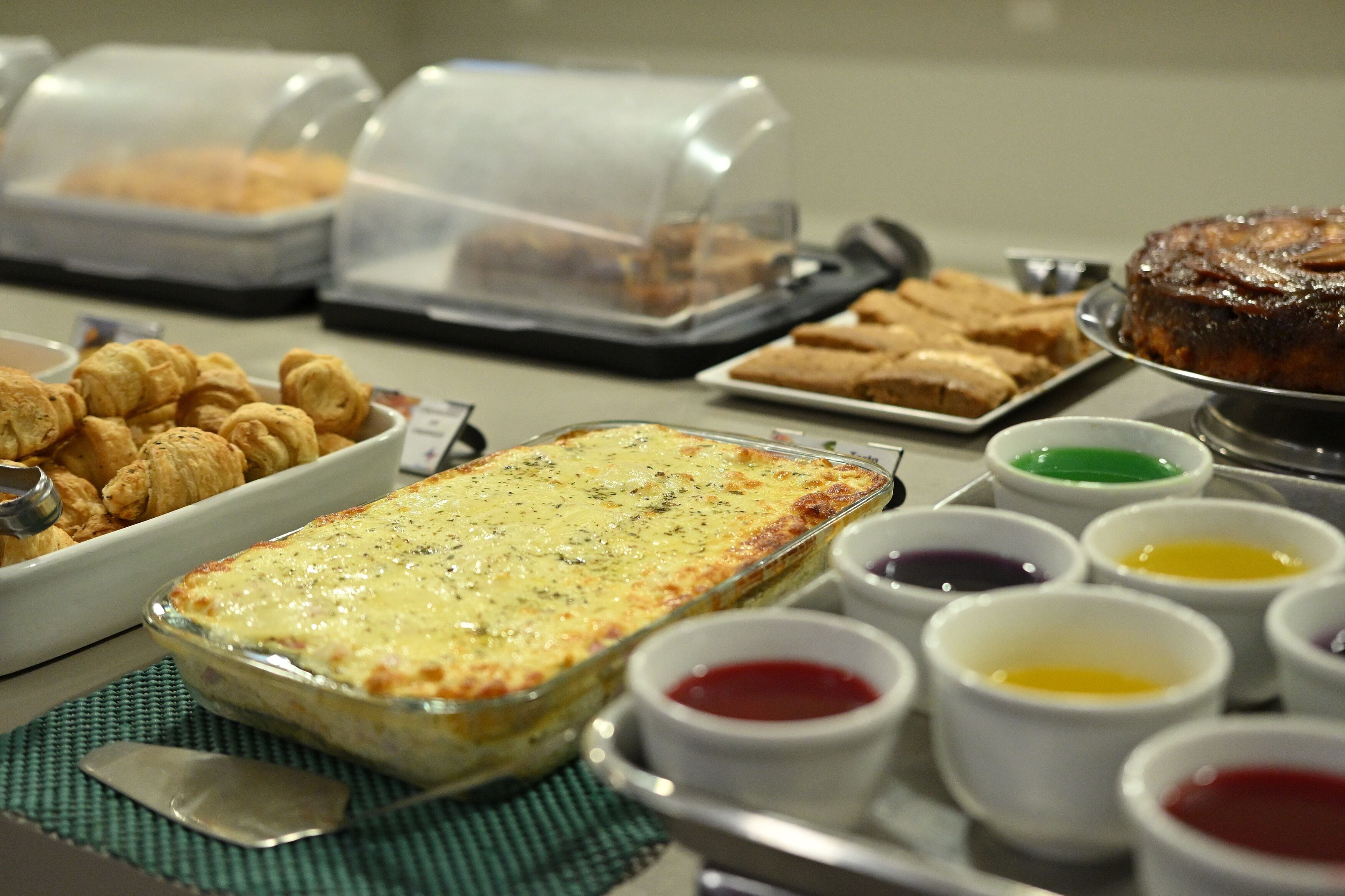 A buffet with various dishes and condiments.