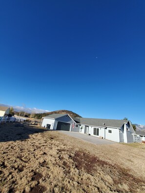 Situated in a rural setting, this two-story house offers a peaceful retreat with a garage and a fenced pasture.