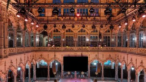 A grand hall with ornate architecture, multiple levels, and a central stage. - Sapphire House Antwerp, Autograph Collection (Antwerp)