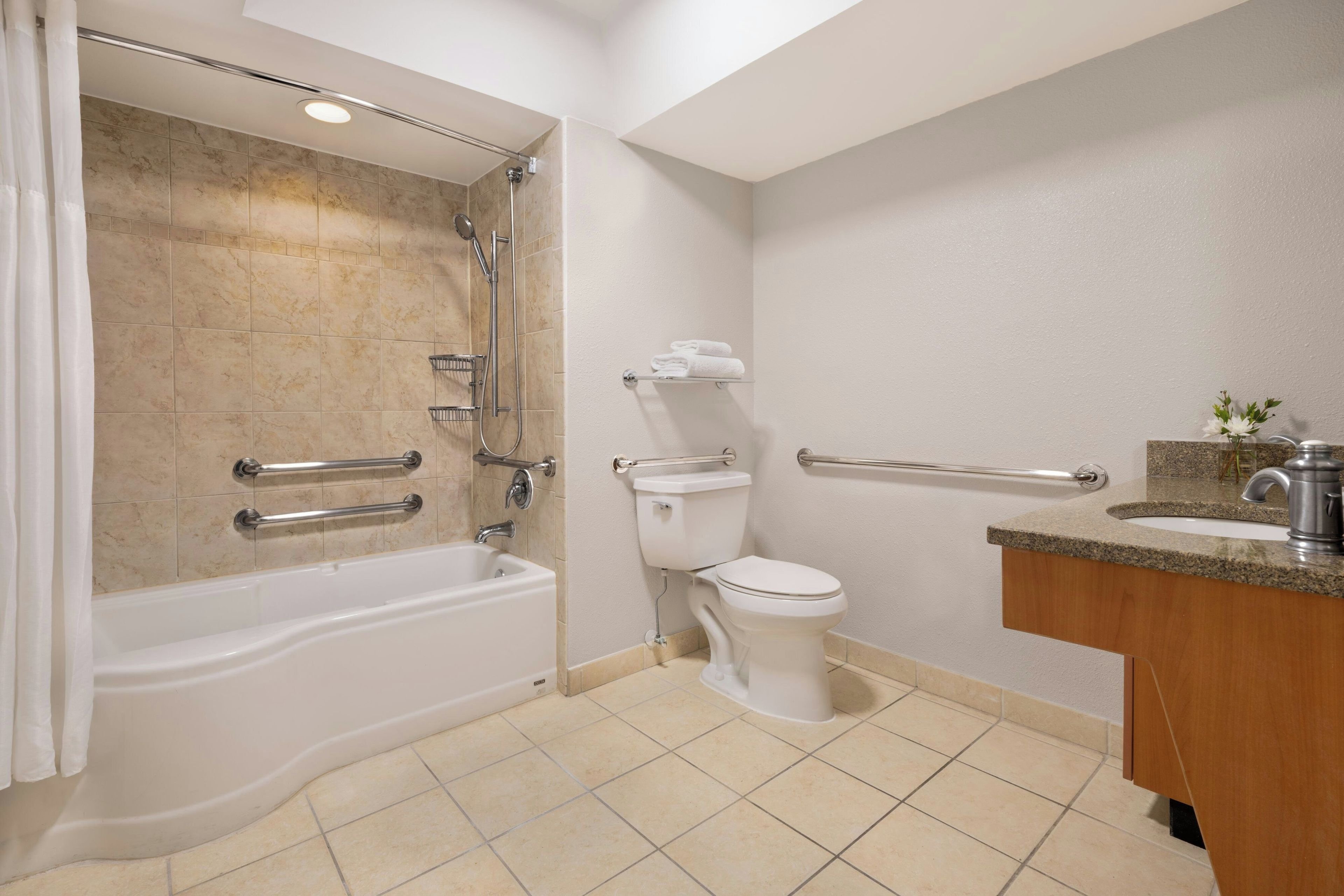 A bathroom with a bathtub, toilet, and sink.