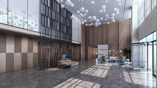Eine geräumige Lobby mit modernem Design, inklusive einer Wandverkleidung aus Holz, einer Sitzecke mit Sofas und einer Decke mit hängenden, kugelförmigen Leuchten.
