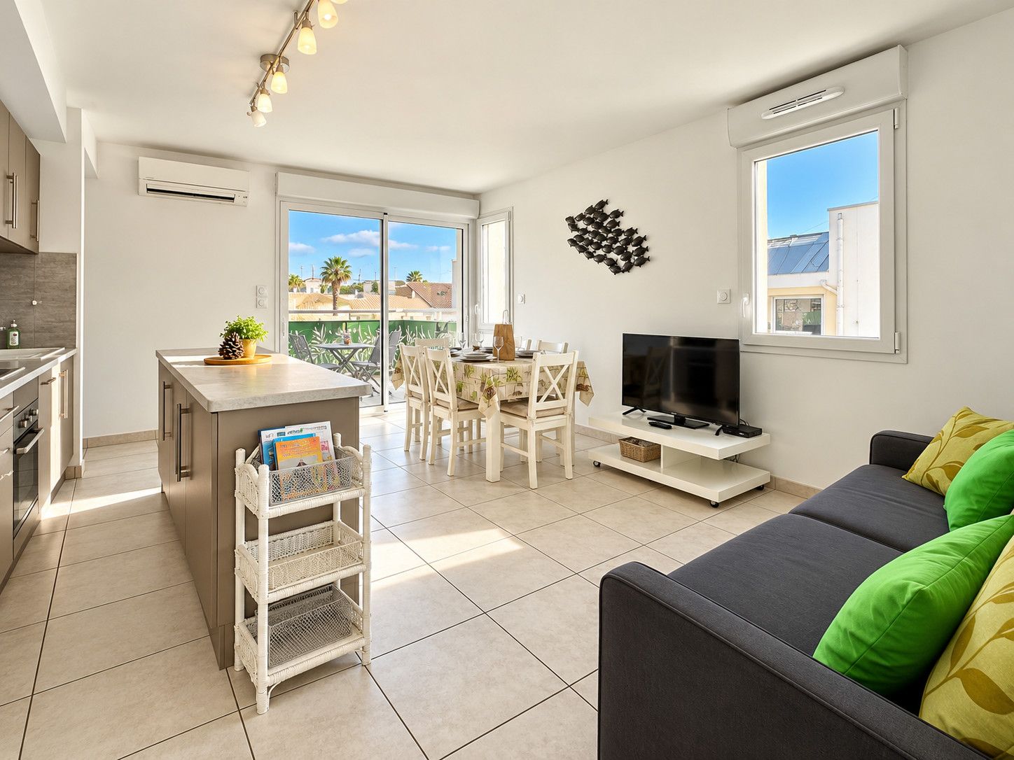A modern apartment with a kitchen, dining area, and living room.