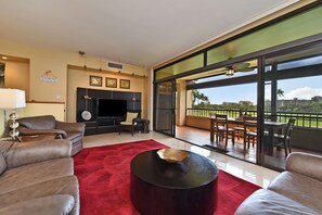 Relax in a spacious living area with a sofa, armchairs, and flat-screen TV.
