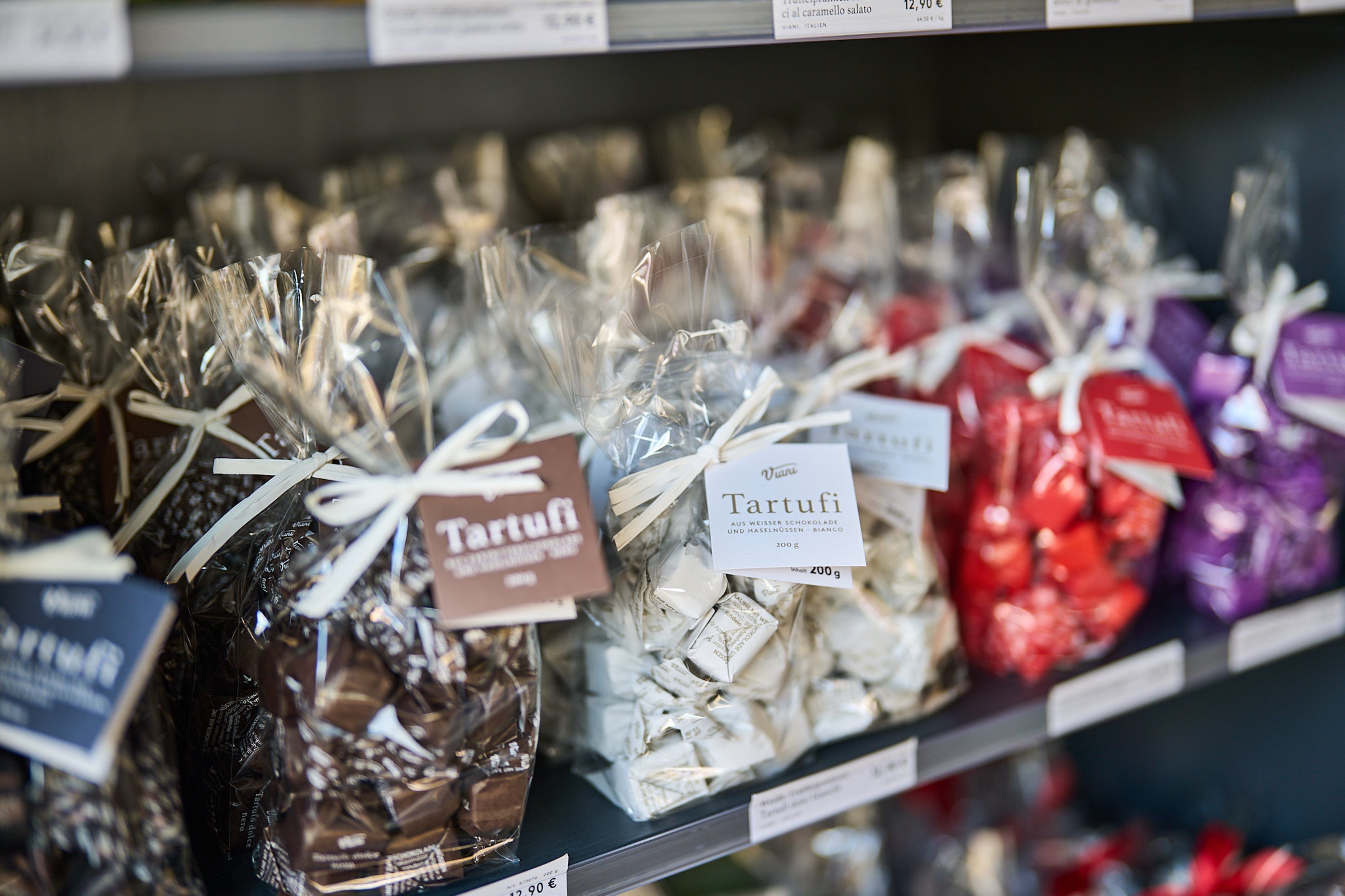A shelf with various chocolate bars in different packaging.