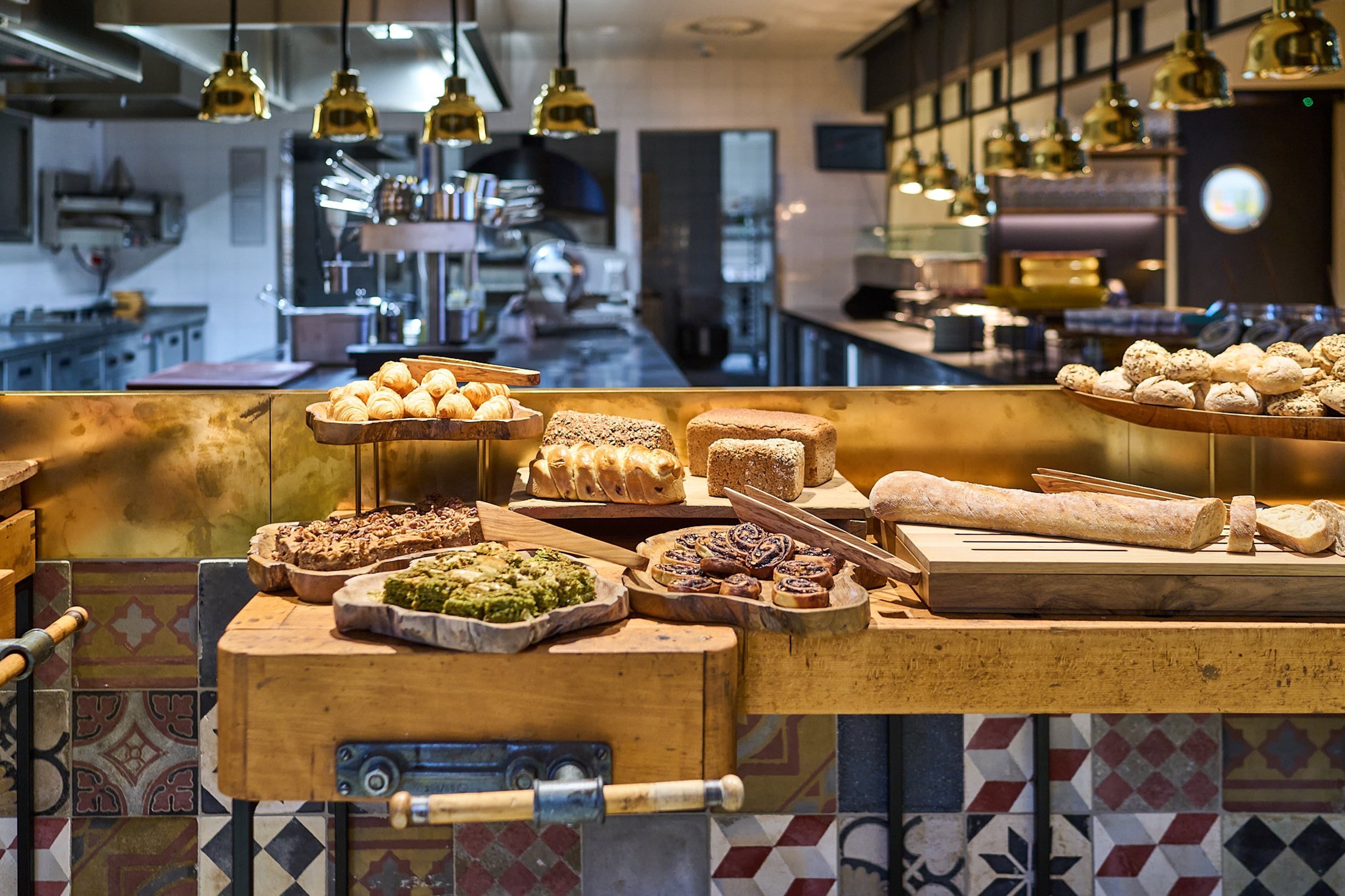 A bakery counter with various baked goods and a rolling pin.