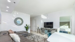 A modern living room with a sofa, TV, and a glass table. - 4309 the club  · PENTHOUSE Oceanview 4bedroom freeparking @brickell (Miami)