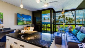 A modern kitchen with a large island, a dining area with a view, and a seating area with a view. - Enjoy Your Oceanside Dream at Kihei Surfside (Kihei)