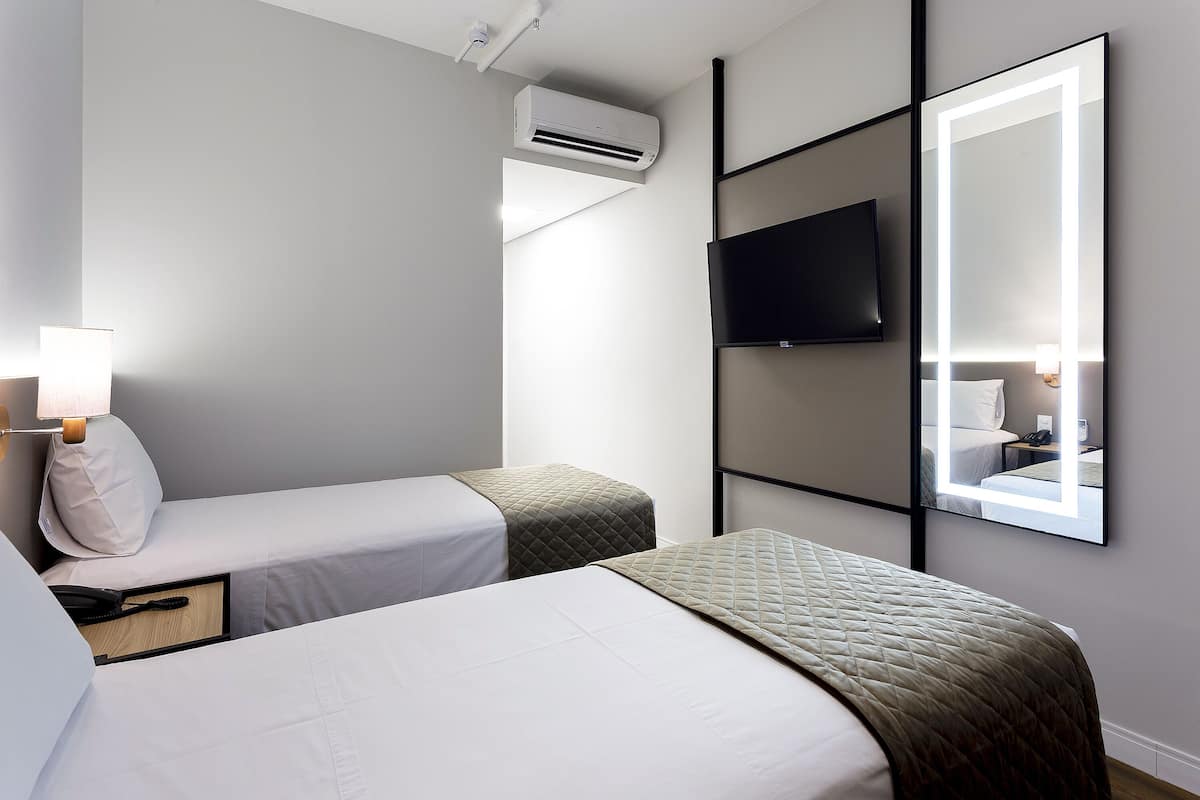 deluxe twin room | minibar, in-room safe, desk, laptop workspace
