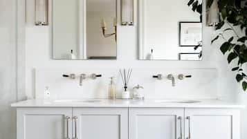 Bathtub, hair dryer, towels, toilet paper