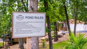 A sign listing the rules for using a pond at Sunset Hills Cottages. - COZY COTTAGE - Private Hot Tub and Fire Pit (Branson)