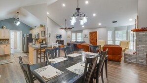 A spacious living area with a dining table set for four, a kitchen with modern appliances, and a fireplace. - Holly Lake Retreat w/ 2 Community Pools & Yard (Holly Lake Ranch)