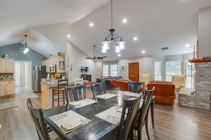 A spacious living area with a dining table set for six, a kitchen with modern appliances, and a fireplace. - Holly Lake Retreat w/ 2 Community Pools & Yard (Holly Lake Ranch)