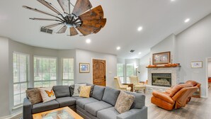 A spacious living room with a sectional sofa, a leather recliner, a fireplace, and a ceiling fan. - Holly Lake Retreat w/ 2 Community Pools & Yard (Holly Lake Ranch)
