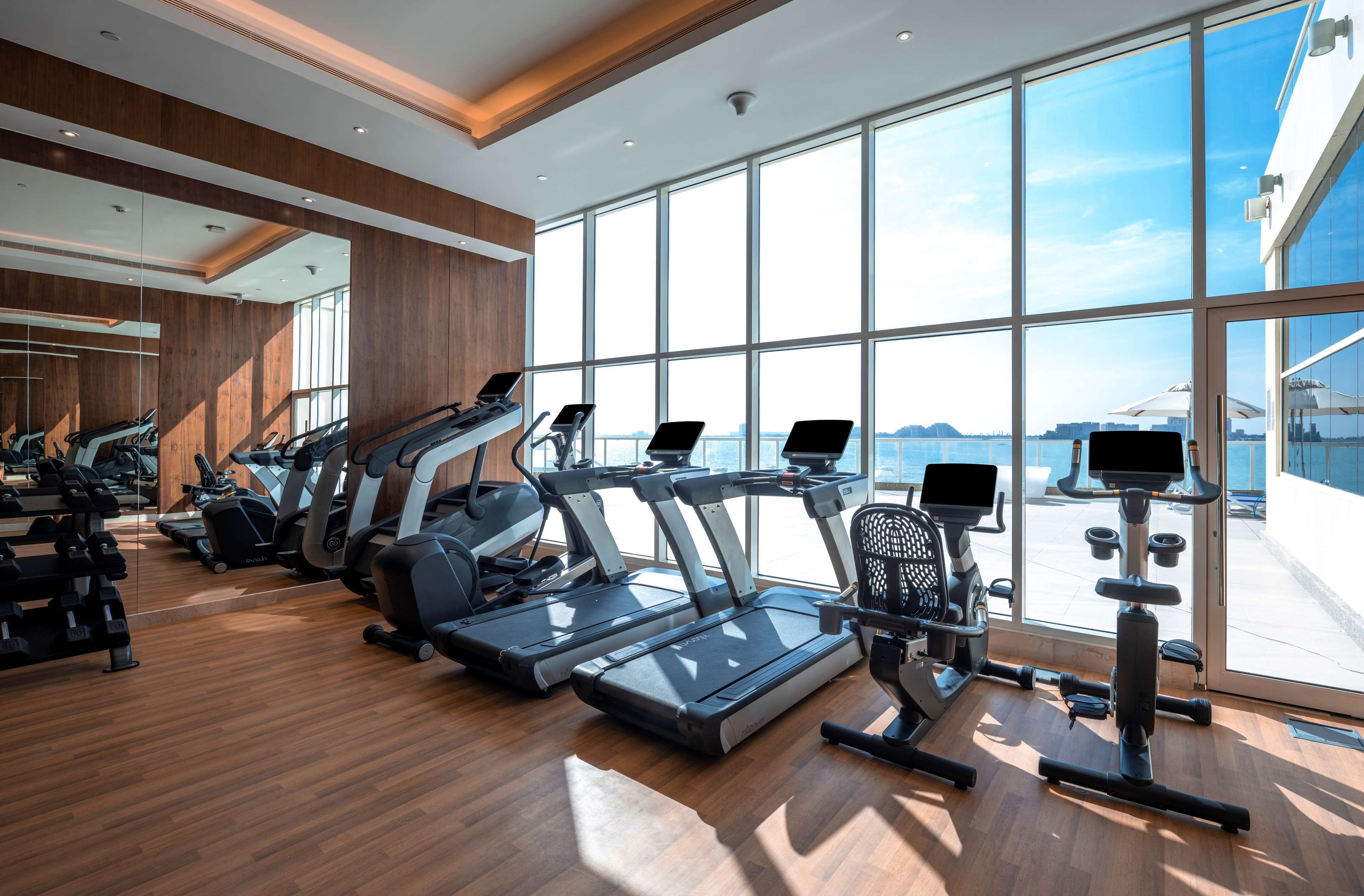 A gym with treadmills, stationary bikes, and weight machines.