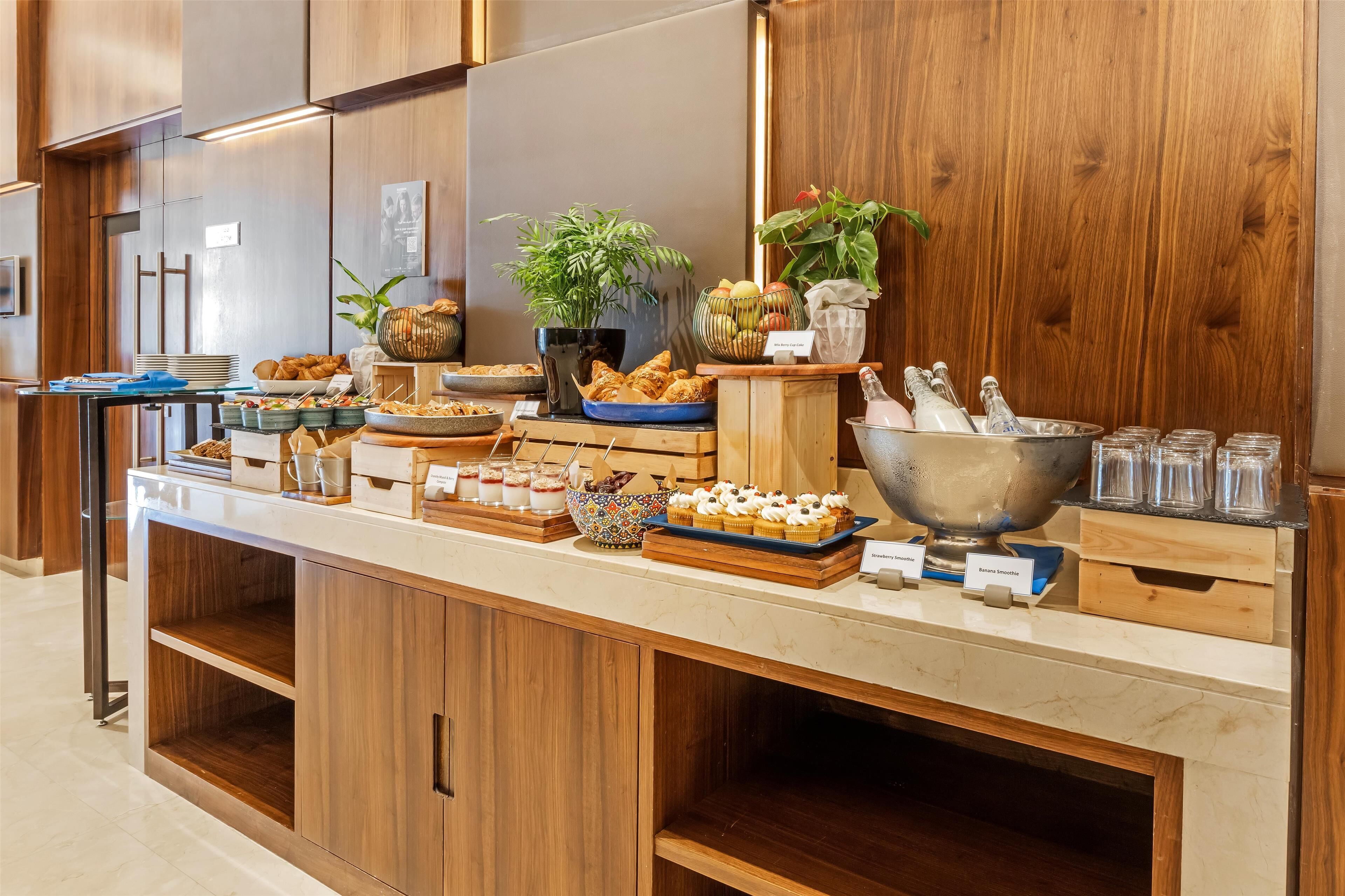 A buffet setup with various food items and a coffee station.