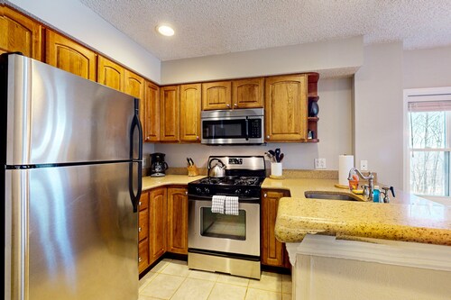 Ski-in/out condo near lifts with a fireplace, pool, hot tub, & tennis