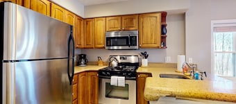 Ski-in/out condo near lifts with a fireplace, pool, hot tub, & tennis