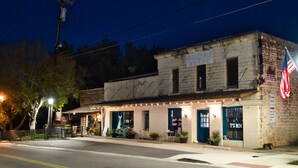 A historic building with a sign reading "Sugar Shack" and an American flag.