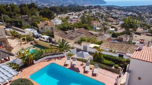 A residential area with a swimming pool, white houses, and a view of the sea. - El Olivo by Interhome (Moraira)