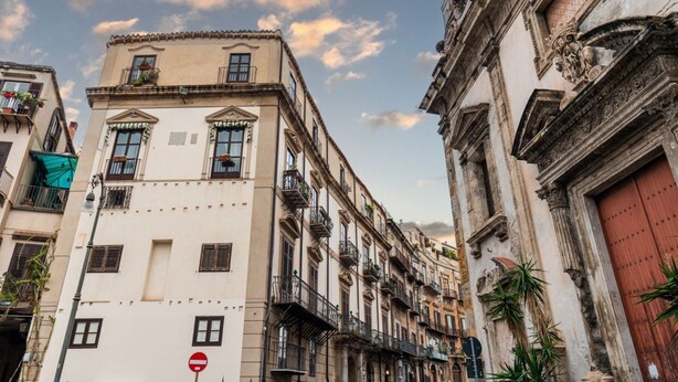 A row of historic buildings with balconies and traditional architecture.