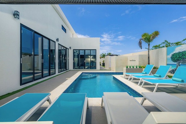 Soak up the sun in style by the pool, complete with comfy lounge chairs for the ultimate in relaxation and laid-back vibes.