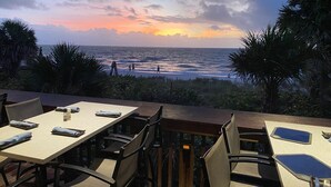 A restaurant with outdoor seating overlooking the ocean at sunset. -  **GEM!**3 BR BEACH HOUSE w/ HEATED POOL, short ride to the beach!  (Naples)