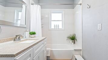 Combined shower/tub, hair dryer, towels, soap