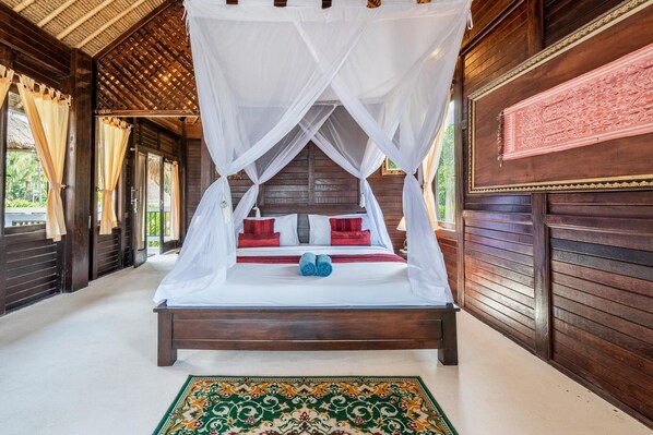 A bed with a canopy, wooden walls, and a patterned rug.
