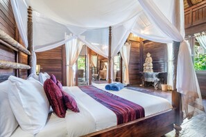 A bed with white and red pillows, a purple blanket, and a canopy. - Superior Oceanview Group Stay – 2 Levels, Separate Entrances | The Village of Angels Resort (Kabupaten Karangasem)