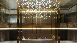 A lobby with a reception desk, marble flooring, and a decorative ceiling with hanging elements. - The Park Indore (Indore)