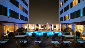 A rooftop pool area with lounge chairs and a bar. - The Park Indore (Indore)