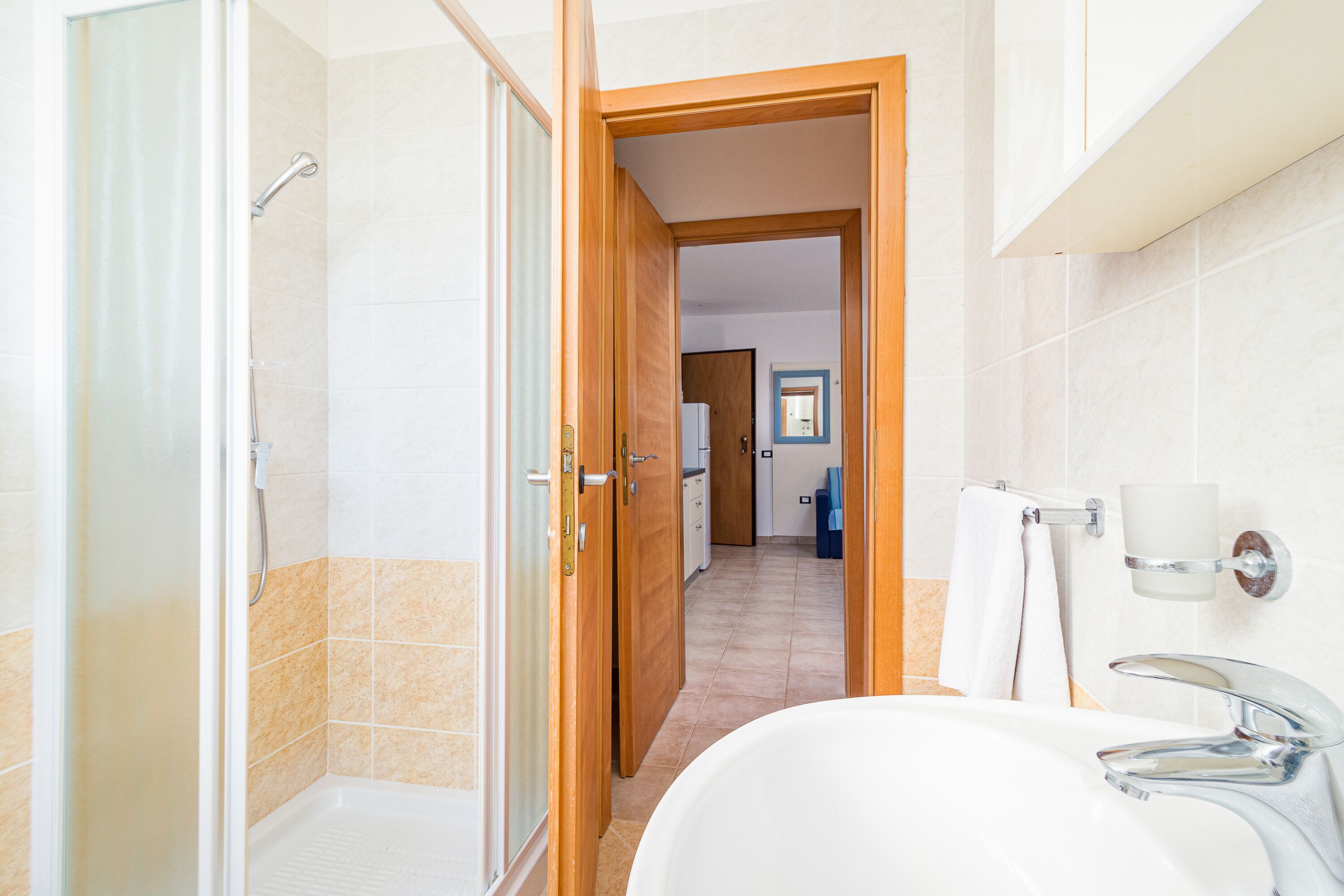 A bathroom with a shower, a sink, and a toilet.