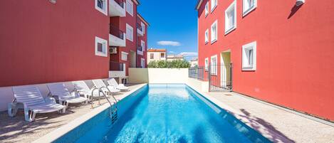 Seasonal outdoor pool, open 8:00 AM to 8:00 PM, sun loungers