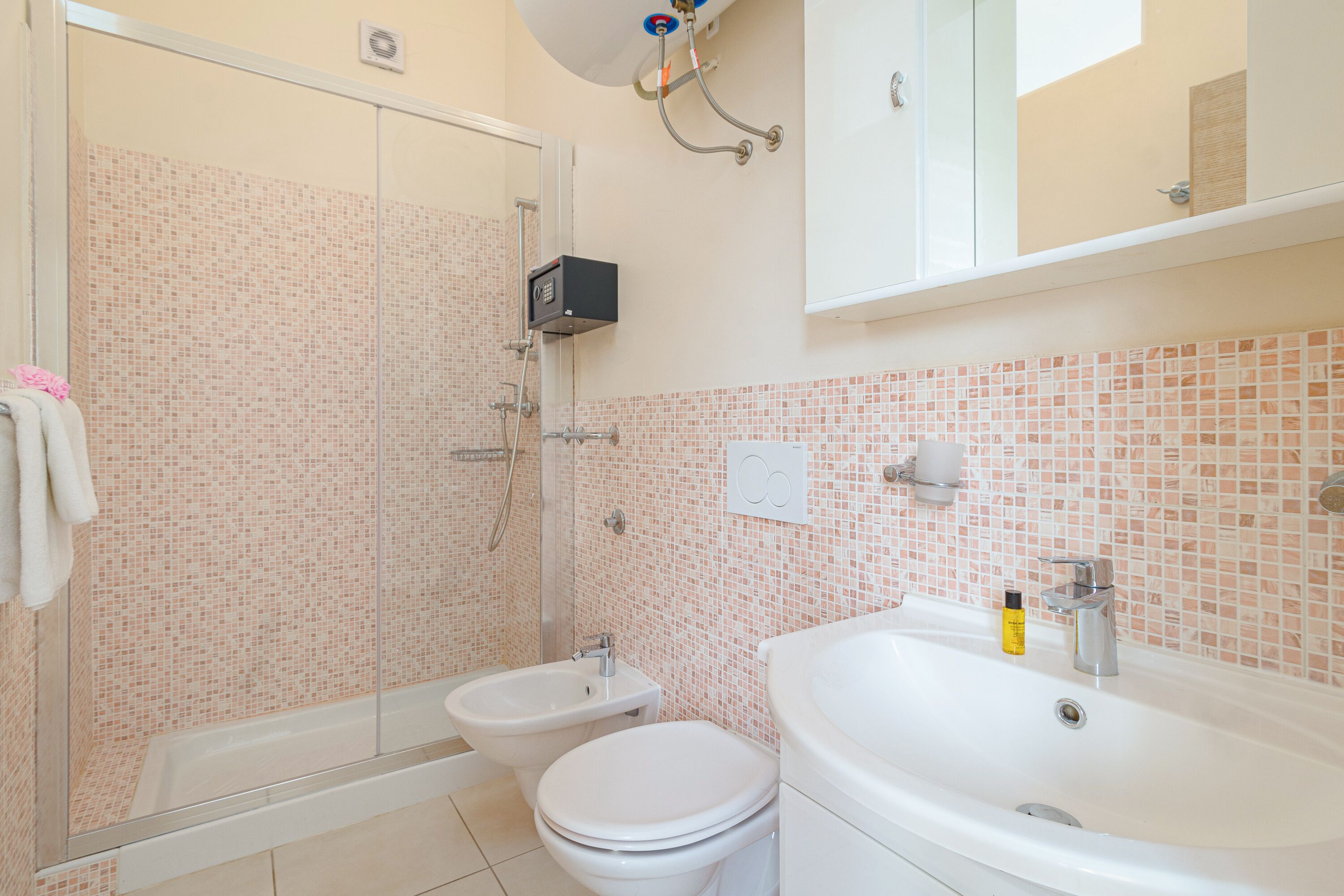 Ein Badezimmer mit Dusche, Bidet, Toilette und Waschbecken.