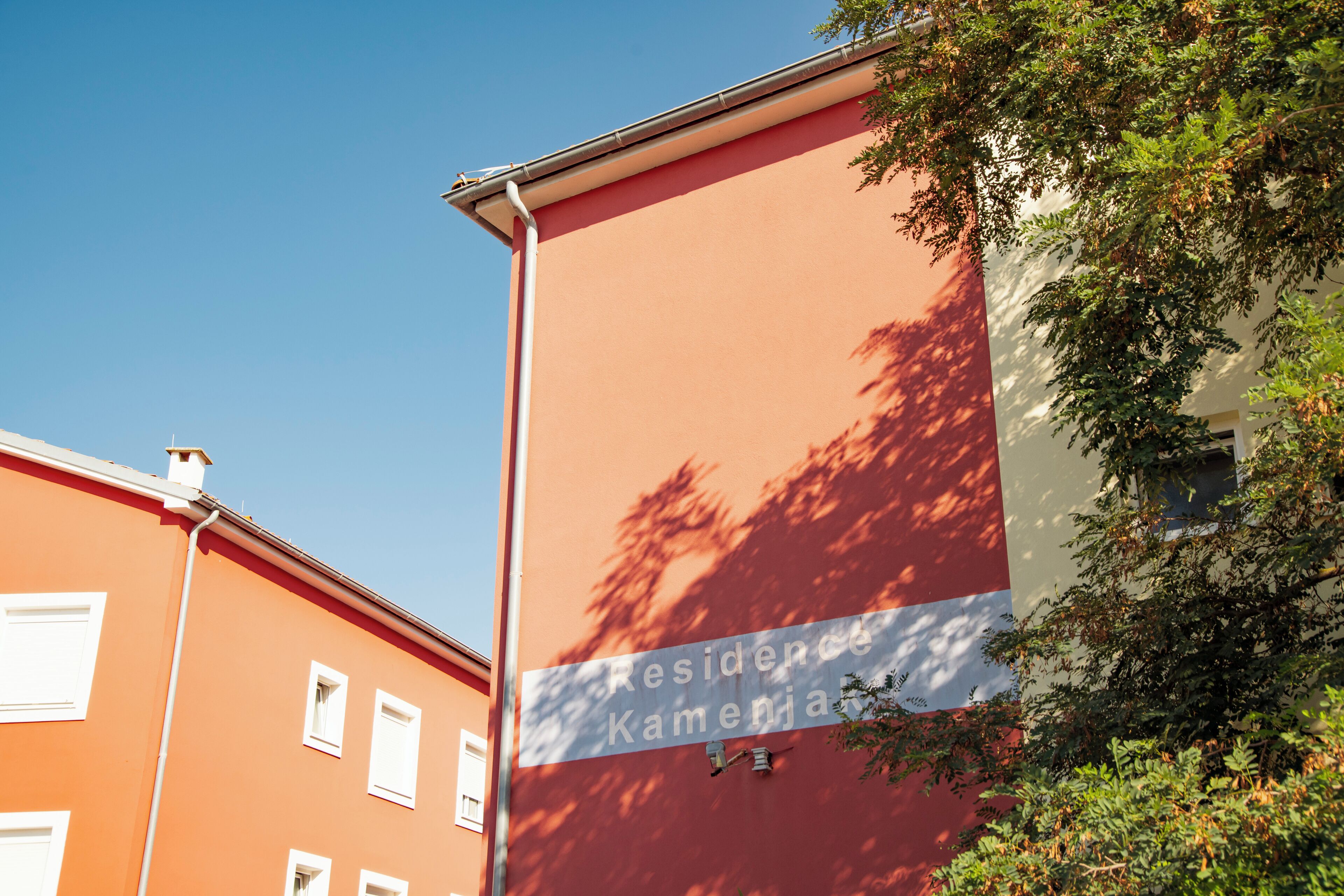 A building with a sign reading 'Residence Kamenja.'