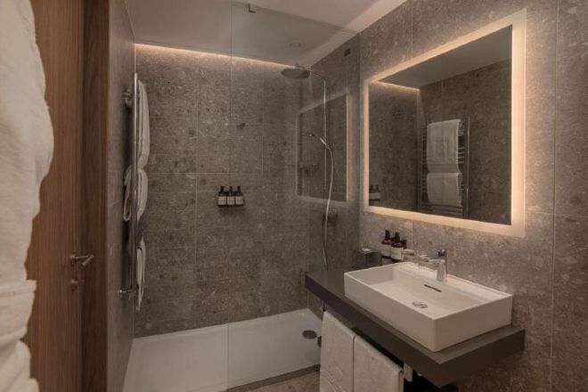 Bathroom | Rainfall showerhead, eco-friendly toiletries, hair dryer, bathrobes